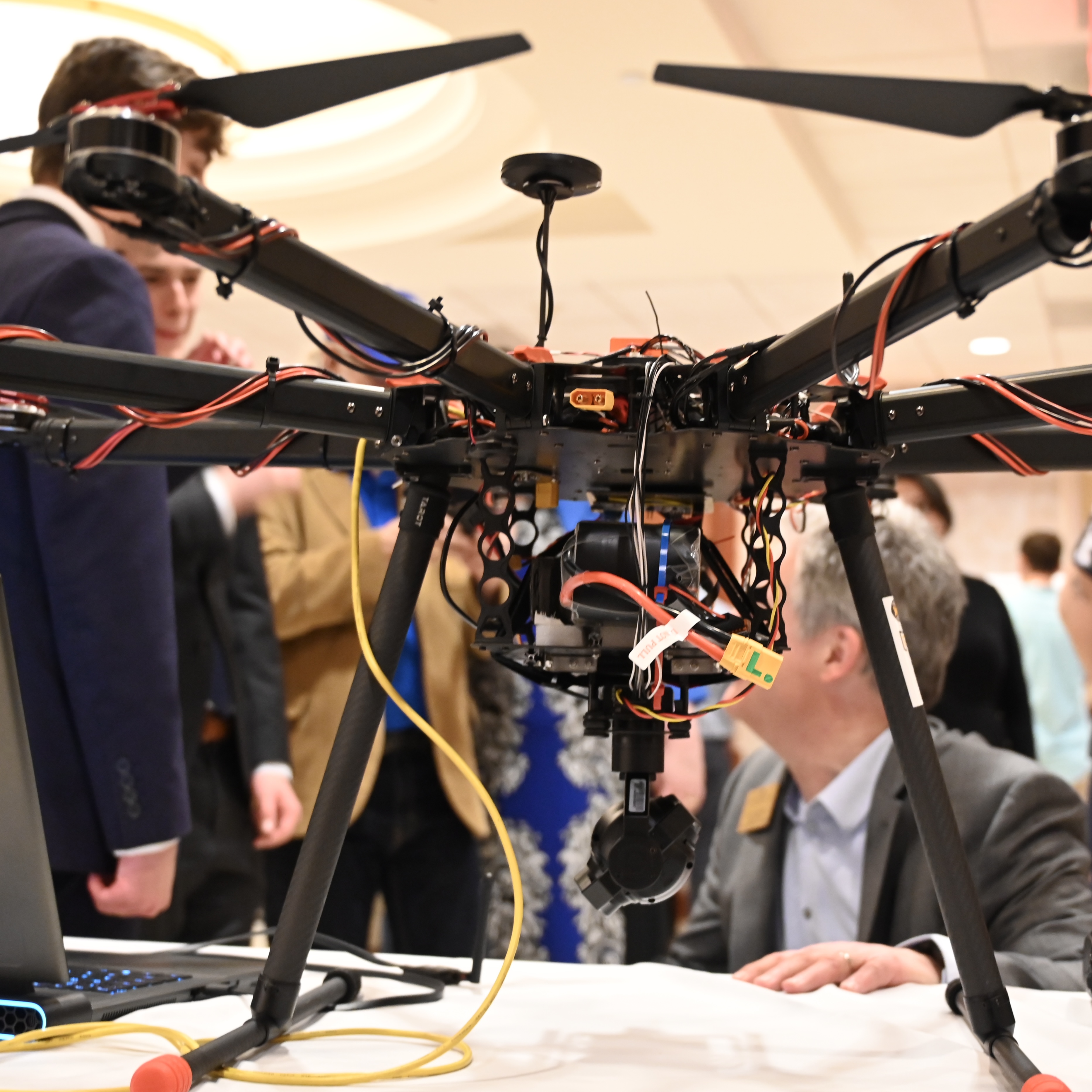 Students at a poster session presenting research findings