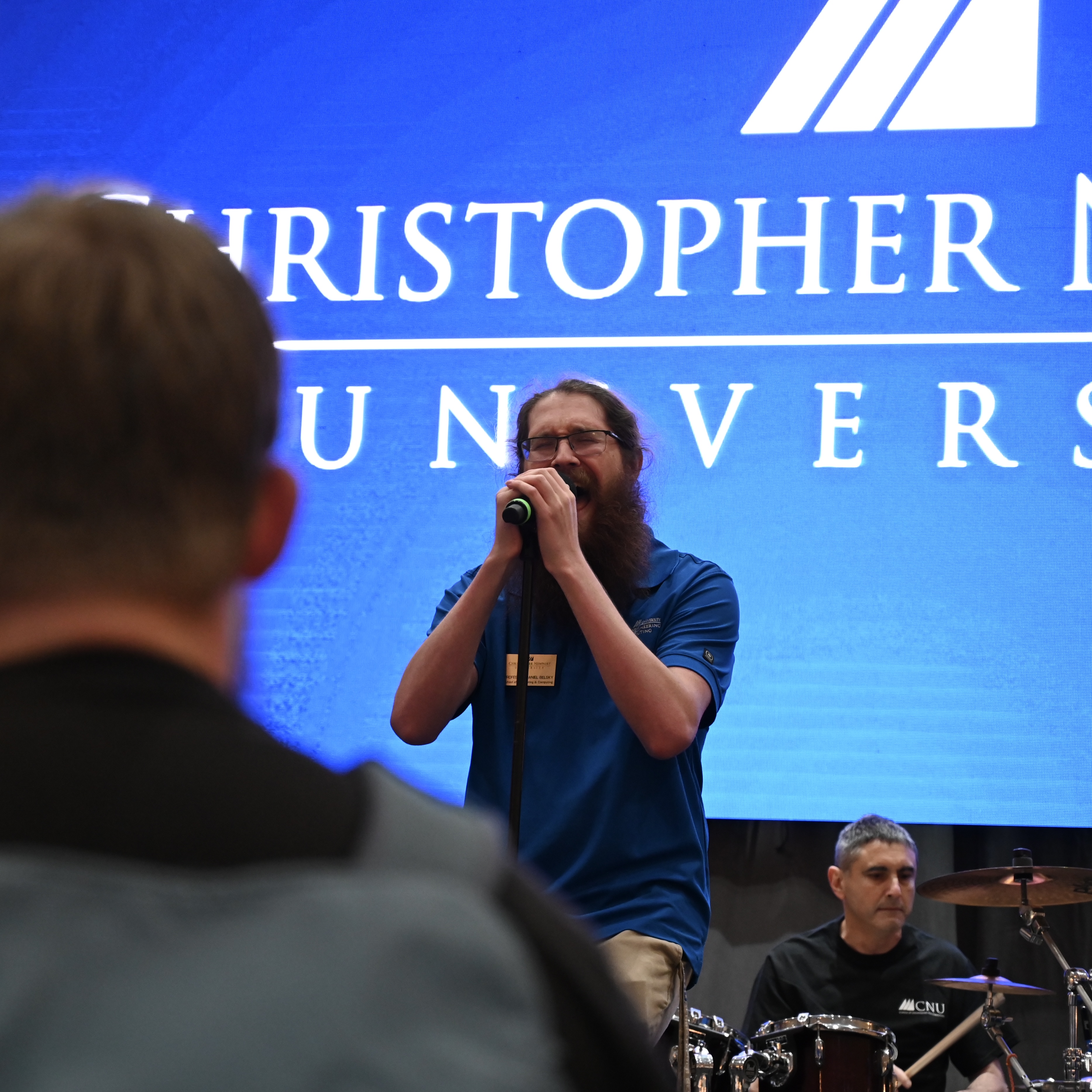 Students discussing their capstone project with event visitors