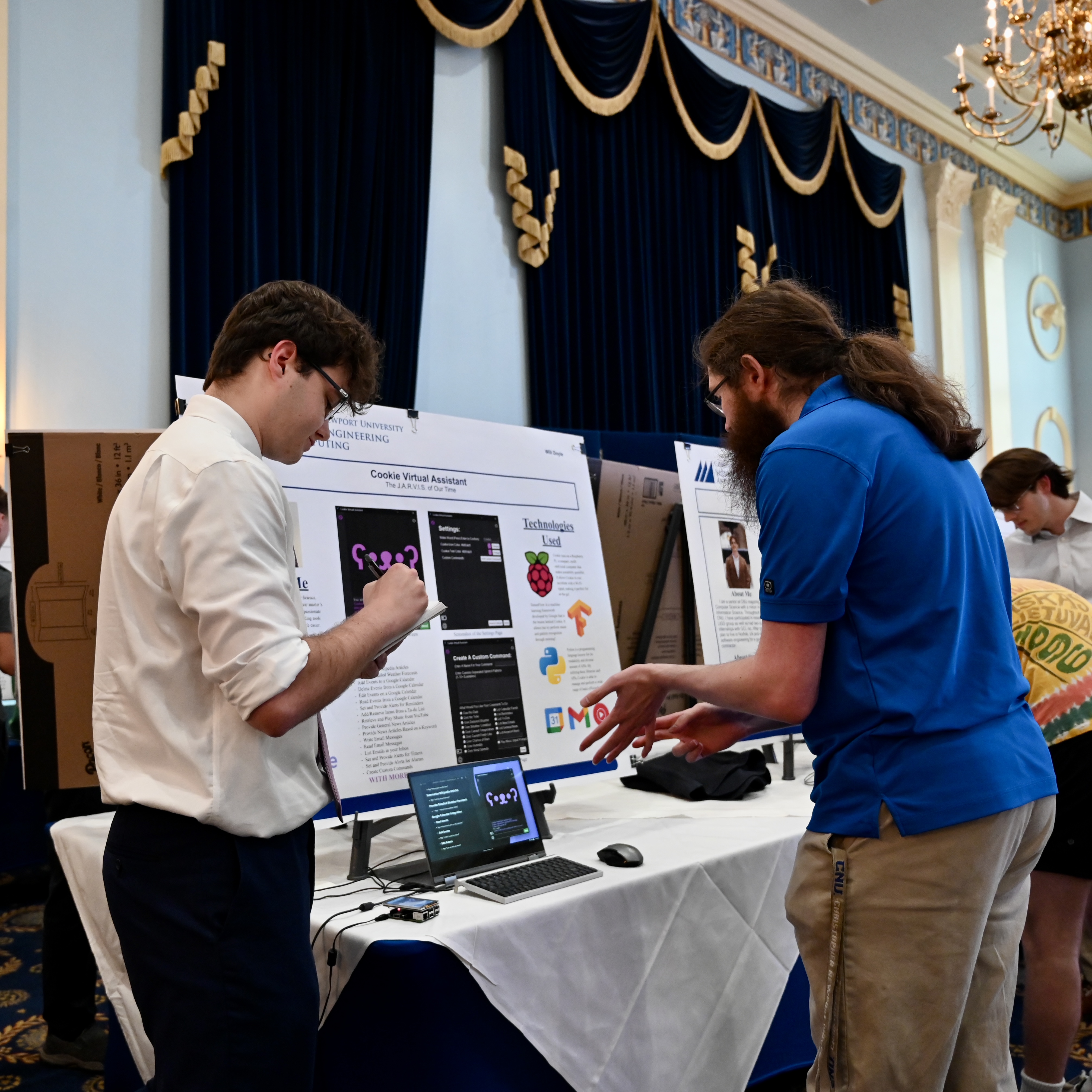 Faculty member reviewing a student capstone project poster